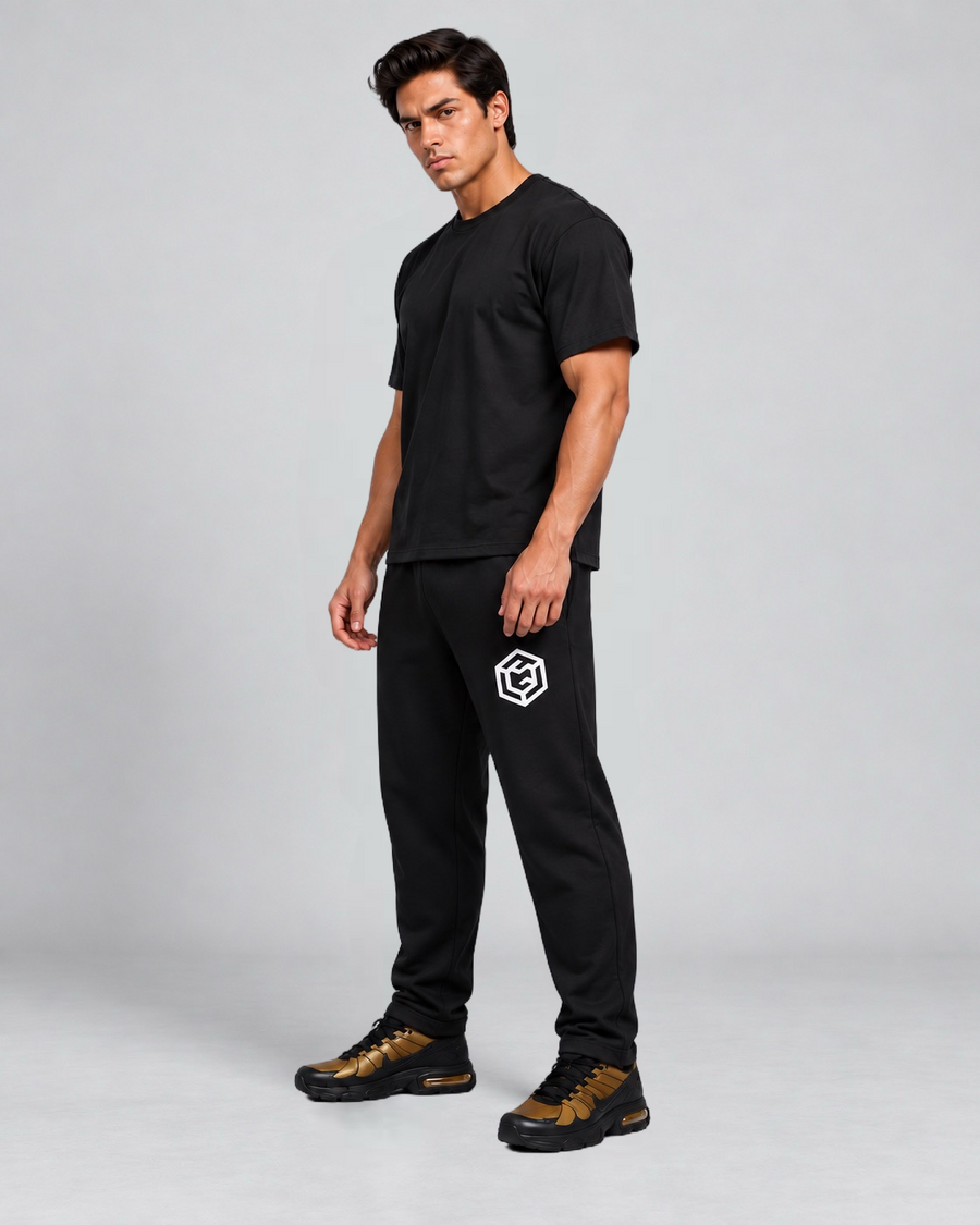 LGLGFG Canon Joggers in Black worn by model, full length. Men's relaxed fit joggers