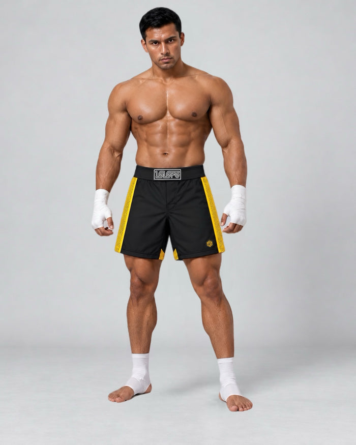 LGLGFG Calibra MMA combat shorts in black with gold side panels, model front view