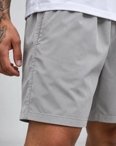 LGLGFG Nexus Board Shorts in Light Grey worn by model, close up third angle